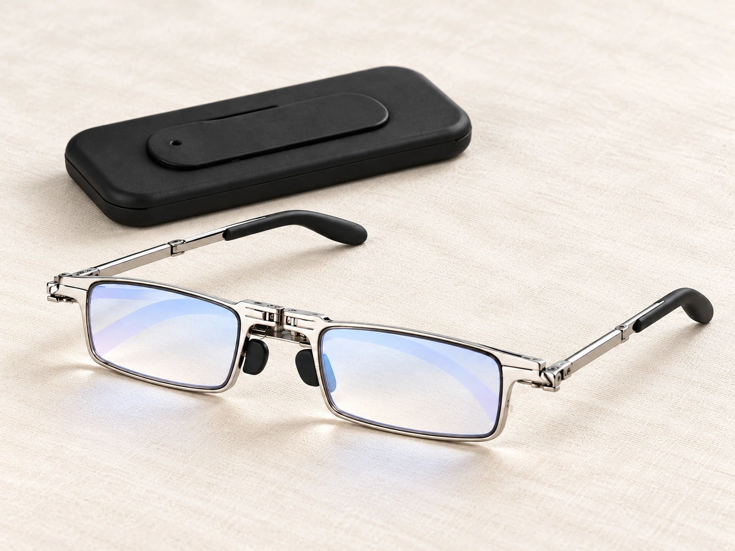 Silver folding readers and a slim black carrying attachment